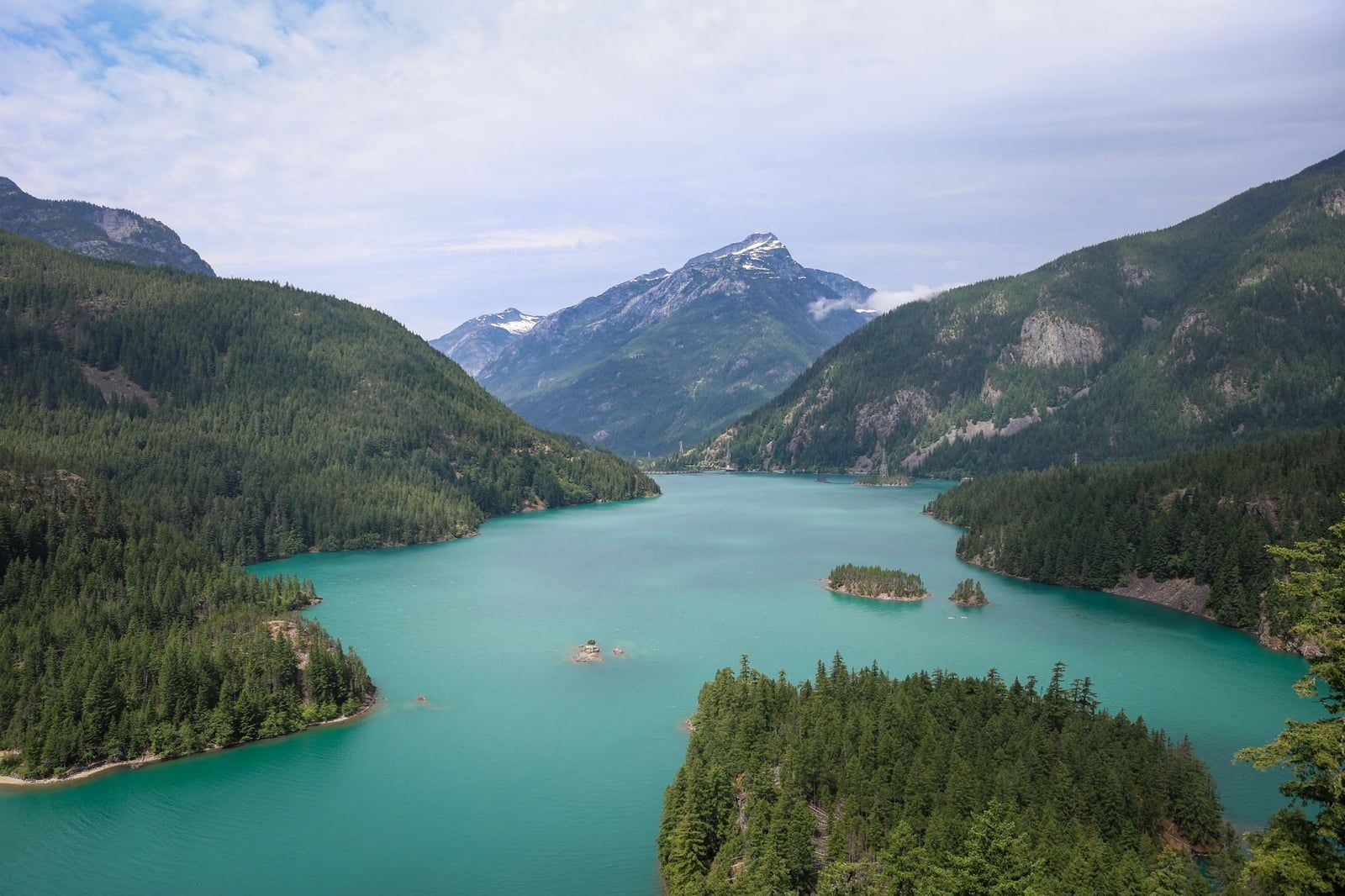 Turquoise waters of Diablo Lake wind between forested mountain slopes in North Cascades National Park.